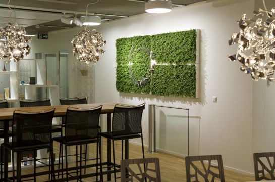 Raum mit Hochtischen und Hochstühlen grünes Bild an der Wand