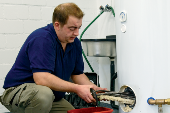 Servicetechniker entkalkt Boiler